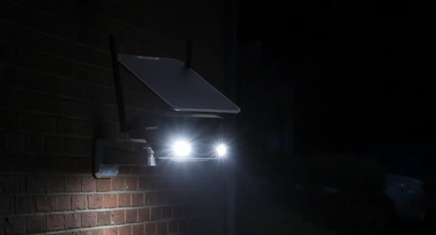 Duvara monte edilmiş, ışıkları yanan bir ESK-180 WiFi güvenlik kamerası.